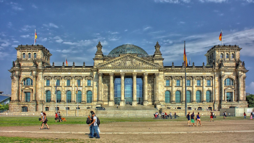 Nachhaltiges Berlin-Reisen: Reichstagsgebäude mit Glaskuppel und Menschen davor