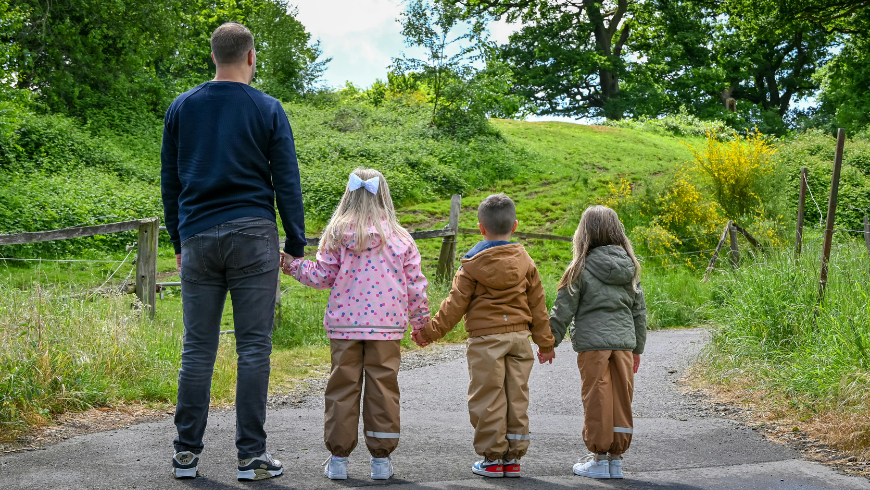 Familie zusammen auf einem Wanderweg im Urlaub