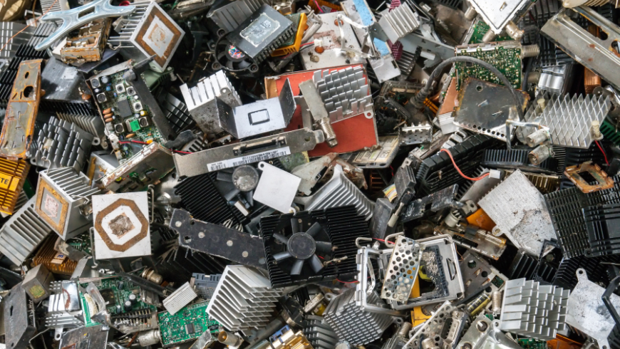 Elektroschrotthaufen mit ausrangierten Geräten wie Smartphones und Computern, Symbol für technologische Umweltverschmutzung und Recycling seltener Erden.